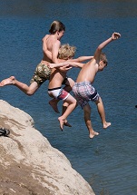 Boys jumping into water. Sorensen