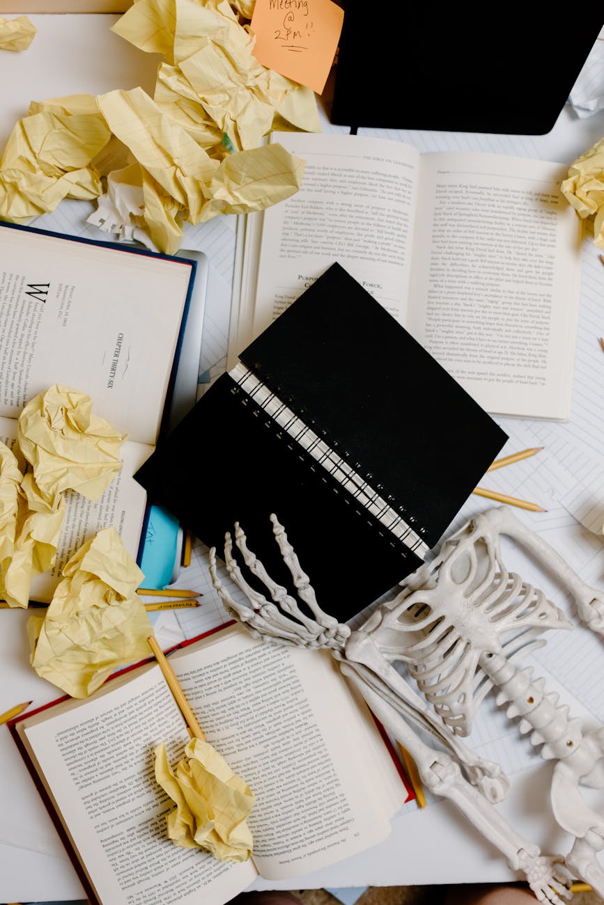 black notebook beside white skeleton